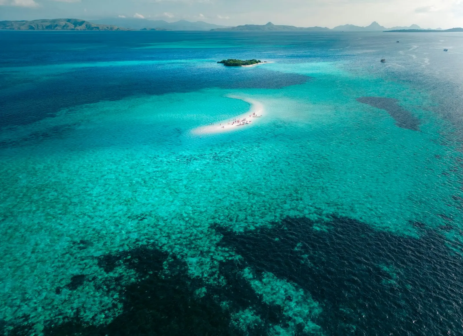 A large body of water with a small island in the middle of it