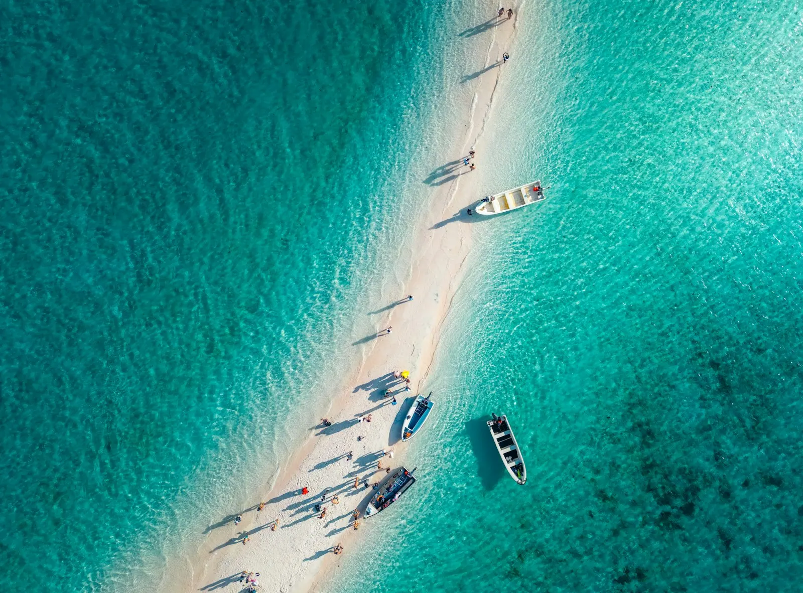 A group of boats floating on top of a body of water