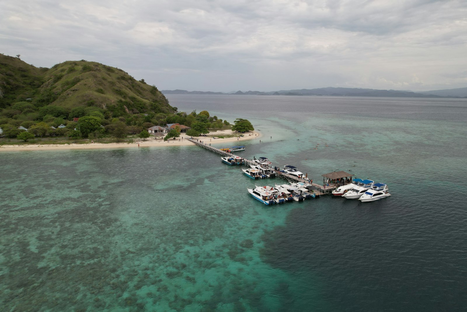 A group of boats floating on top of a body of water